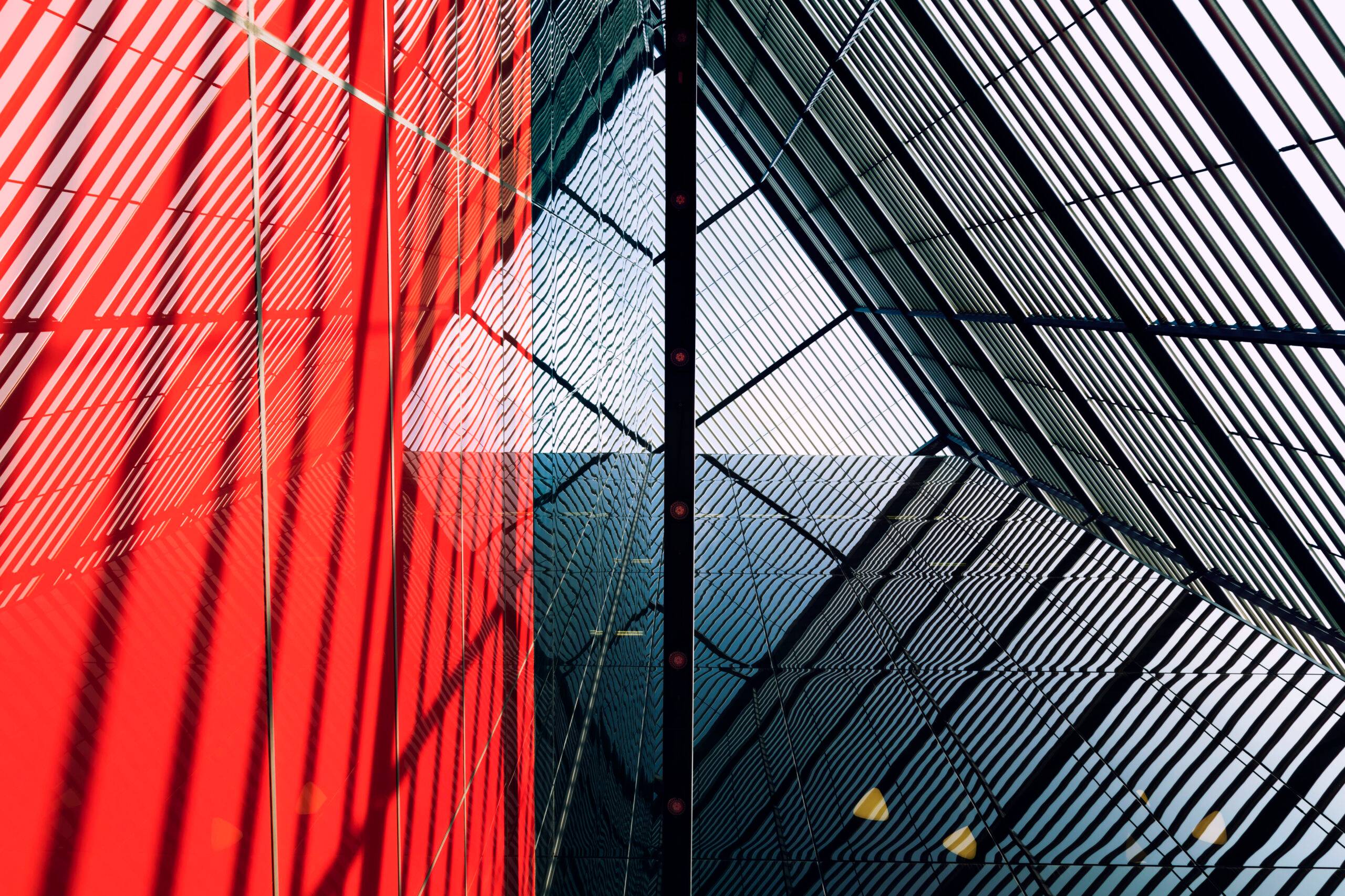 Internal steel structure of modern car park, public building, red and black colors