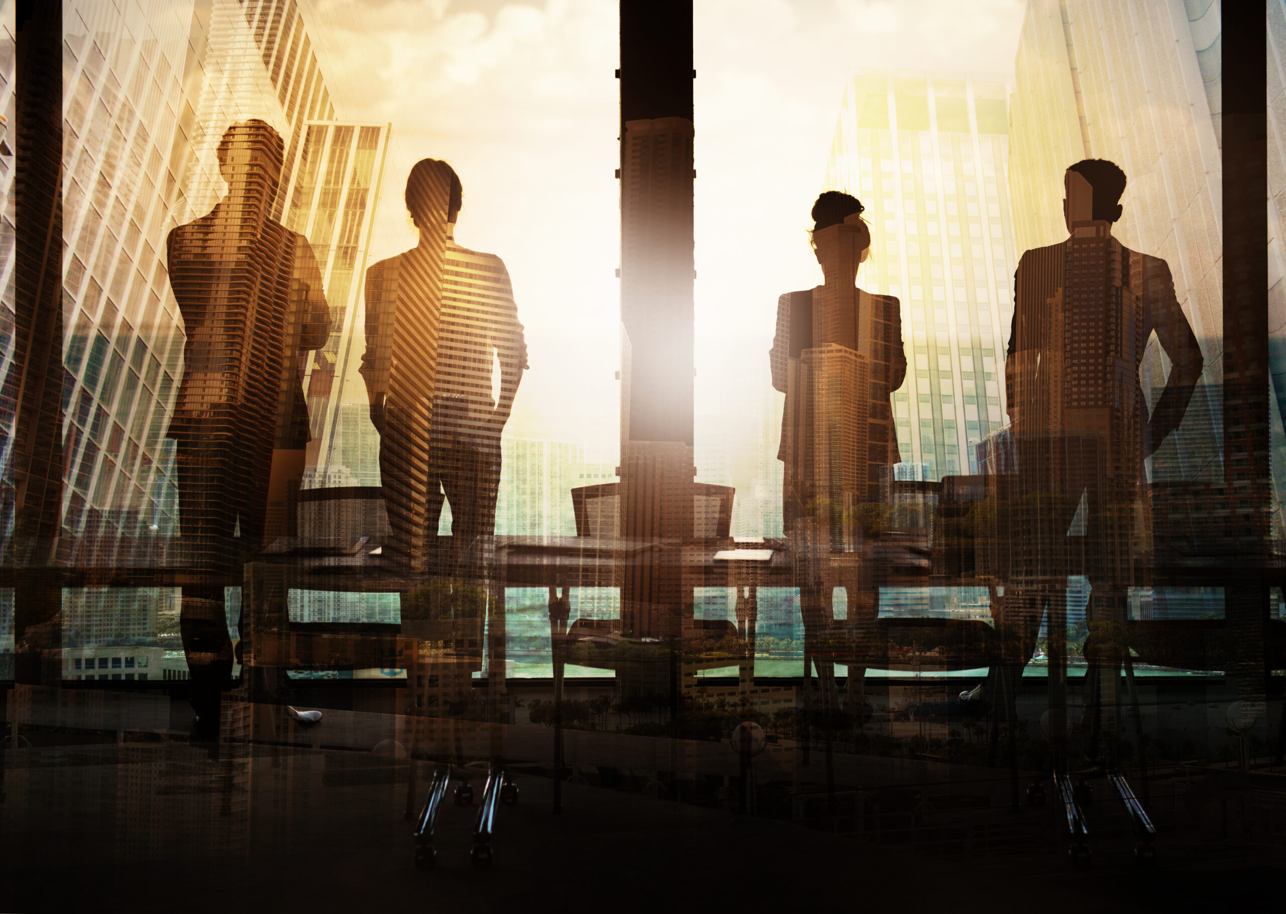 Leaders in a corporate office looking out of a window in building