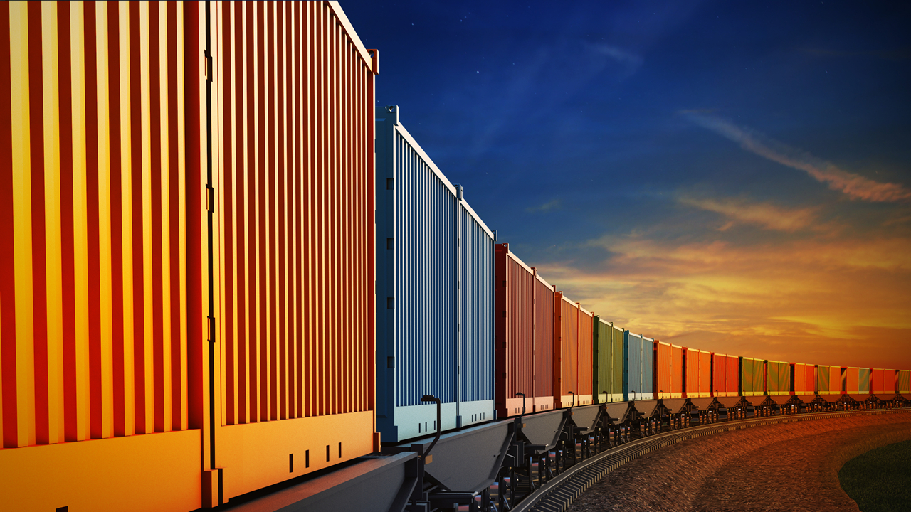 Shipping containers being transferred by railroad