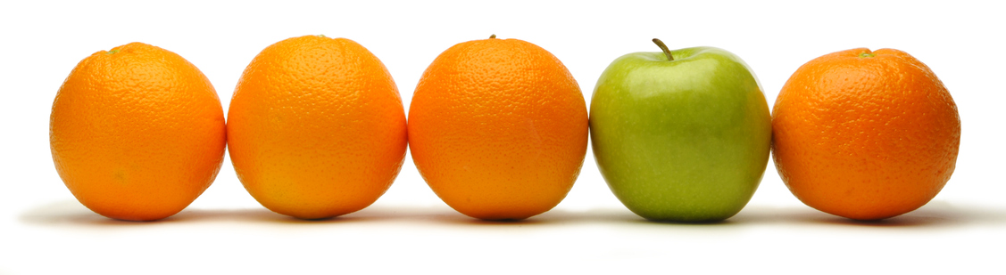 Row of oranges with a green apple.
